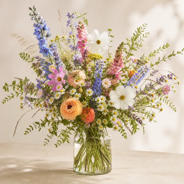 Colorful wildflower arrangement in a clear glass vase